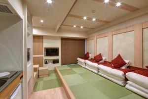 a living room with two couches and a kitchen at Hotel Amaterrace Yosuga in Osaka