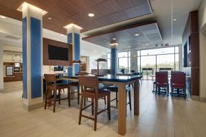 a dining room and kitchen with a table and chairs at Holiday Inn Express & Suites - Elizabethtown North by IHG in Elizabethtown