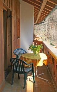a table and chairs on the porch of a cabin at Ferienhaus am Römerweg in Klais