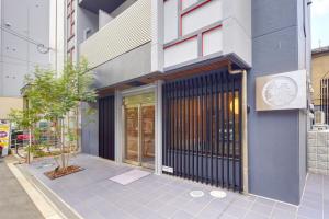a building with a gate in front of it at Hotel Amaterrace Yosuga in Osaka