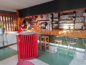 a man standing at the counter of a bar at HOTEL DE LA GARE " Chez Hervé et Manu " in Jussey