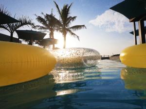 una piscina con el sol reflejándose en el agua en Northstar-Hotel, en Durban