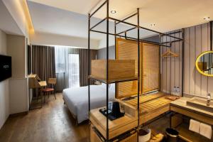 a hotel room with a bed and a sink at PORTA by Ambarrukmo in Yogyakarta
