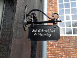 a sign hanging on the side of a building at De vijgenhof in Appingedam