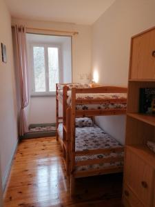 a room with two bunk beds and a window at Domaine de Salomony in Marcols-les-Eaux