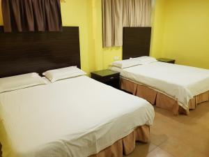 Postel nebo postele na pokoji v ubytování New City Hotel