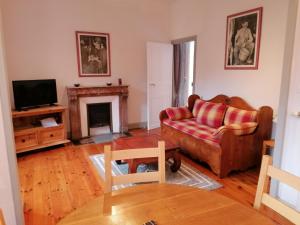 a living room with a couch and a fireplace at Domaine de Salomony in Marcols-les-Eaux