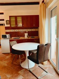 a kitchen with a white table and chairs at Villa Mihaela in Ičići