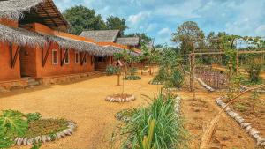 un giardino di fronte a una casa con alberi di Ayurvie Sigiriya - Ayurvedic Retreat by Thema Collection a Sigiriya