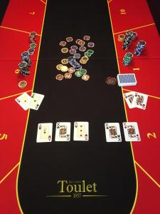 a table with a bunch of poker cards and playing cards at La Forestière in Monclar-de-Quercy