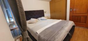 a bedroom with a large bed in a room at Apartments Kolak in Rogoznica