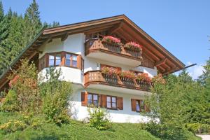 a building with flower boxes on the balconies on it at Ferienhaus am Römerweg in Klais