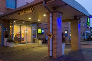 a store front with blue lights on the front at Holiday Inn Express East Midlands Airport, an IHG Hotel in Castle Donington