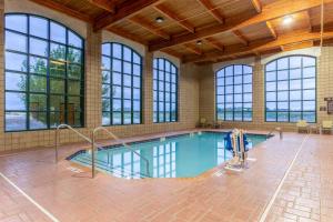 a swimming pool in a building with windows at Holiday Inn Express & Suites Cedar Falls - Waterloo, an IHG Hotel in Cedar Falls