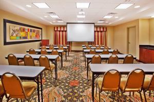 a conference room with tables and chairs and a projection screen at Holiday Inn Express Hotel & Suites Atlanta-Cumming by IHG in Cumming