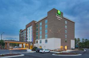 a large white building with a clock on it at Holiday Inn Express & Suites Covington, an IHG Hotel in Covington