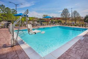 a swimming pool with a pool table and a swimming pool at Holiday Inn Express & Suites Covington, an IHG Hotel in Covington