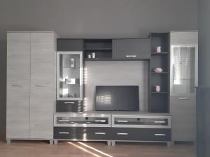 a large entertainment center with a television in a room at ANKER SILVER DREAM in Kaposvár