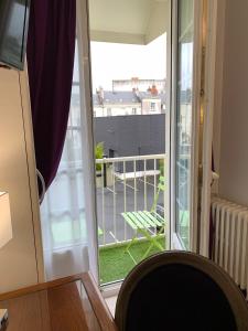 a room with a window and a balcony at Kyriad Saumur Centre in Saumur