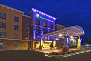 a hotel with a lit up sign in front of it at Holiday Inn Express Hotel & Suites Ann Arbor West by IHG in Ann Arbor