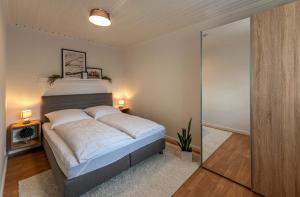 a bedroom with a bed and a sliding glass door at Ferienapartment Weber in Faßberg