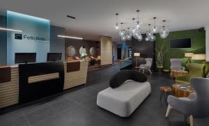 a lobby with a waiting room with a chair and a reception at Spa Hotel Felicitas in Poděbrady