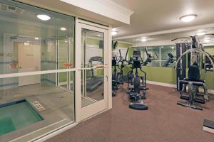 a gym with treadmills and ellipticals in a building at Holiday Inn & Suites San Mateo - SFO, an IHG Hotel in San Mateo