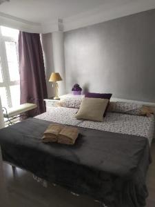 a bedroom with a bed with two pillows on it at Apartamento Balcón de Europa 2A in Nerja