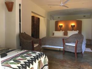A bed or beds in a room at Afrikhaya Guest House