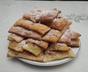 a plate of sugar covered pastries on a table at Herőke Vendégház in Terény