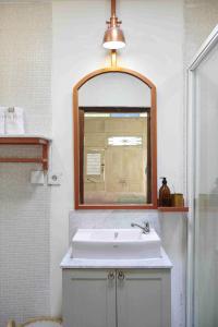 a bathroom with a sink and a mirror at Chendela Yogyakarta in Yogyakarta