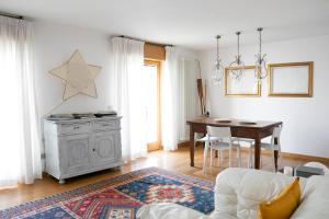 a living room with a table and a dining room at IseoLakeRental - Casa Stella d'Acqua in Sulzano