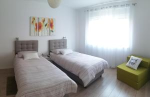 a bedroom with two beds and a window at Apartment DOLEA in Split