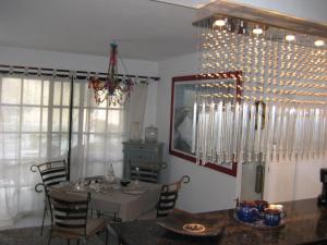 a dining room with a table and a chandelier at Apartment Casa Molino in Mogán