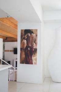 een schilderij van een vrouw aan een muur in een kamer bij Luxury Upmarket Guesthouse 20 on 4th in Rustenburg