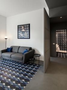 a living room with a couch and a rug at Toraldo Suites - Dimore Partenopee in Naples
