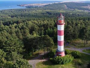 an aerial view of a red and white lighthouse at Lighthouse apartment in Nida +6 photos