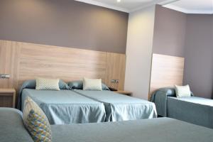 Säng eller sängar i ett rum på Ramblas Hotel