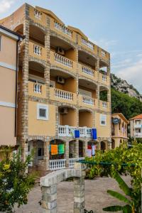 a building with balconies on the side of it at Castellamare Residence in Petrovac na Moru