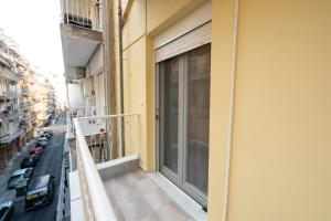 a balcony of a building with a large window at DK Mini Studio White Tower in Thessaloniki