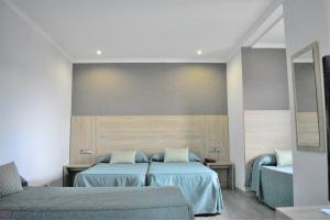 מיטה או מיטות בחדר ב-Ramblas Hotel