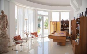 a living room with a glass table and chairs at Villa Alba in Preveza