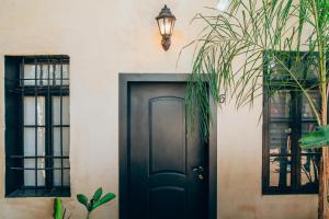 a black door with two windows and a street light at Hotel Anilevich Mansion in Beer Sheva