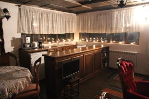 a kitchen with a island with a tv in it at New Bakalov House in Bozhentsi +22 photos