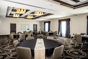 a conference room with tables and chairs in a room at Holiday Inn Express Hotel & Suites Austin NW - Arboretum Area, an IHG Hotel in Austin