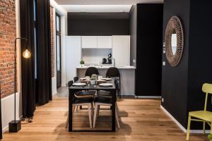 a dining room with black walls and a table and chairs at Smartflats - Bourse Brussels in Brussels