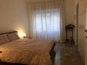 a bedroom with a bed and a large window at Questa casa non è un albergo CIU-ATR 9390-9 in Rome