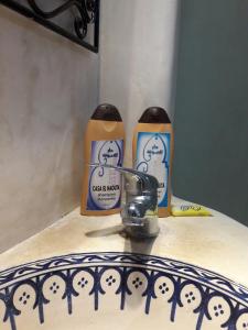 two bottles of candles sitting on a table at Casa El Haouta in Chefchaouene