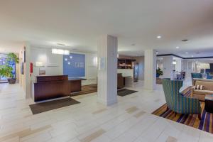 a lobby with chairs and a desk in a building at Holiday Inn Express Baltimore West - Catonsville, an IHG Hotel in Catonsville