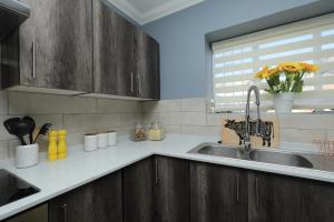 a kitchen with a sink and a window at The View - Luxury Apartment in eMalahleni +20 photos